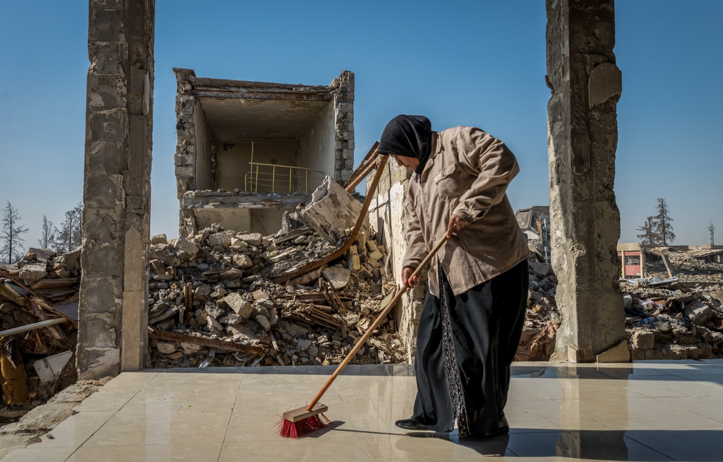 woman cleaning debris